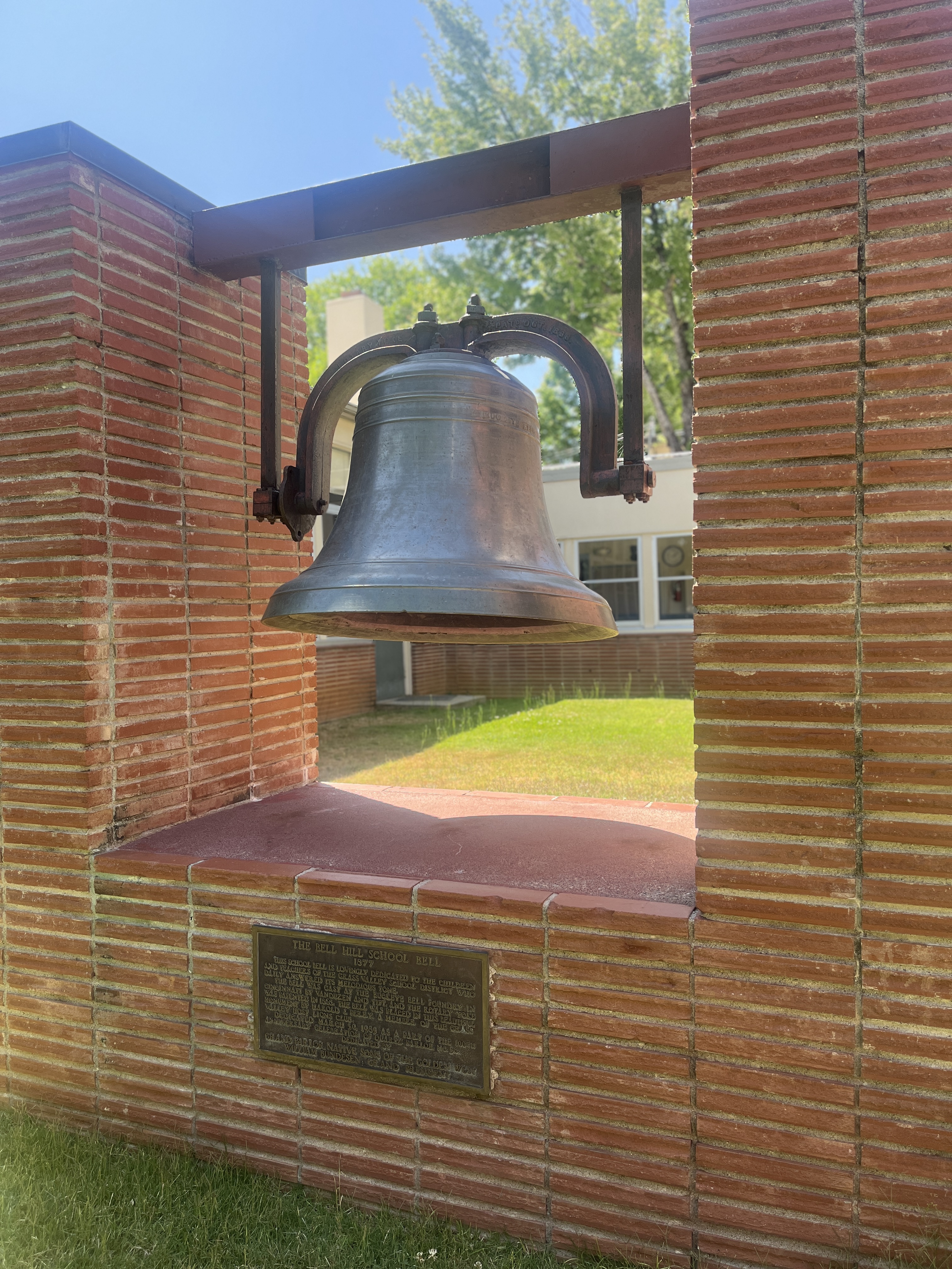 Large school bell in brick framing